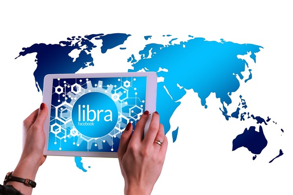 Hands holding a tablet with a world map