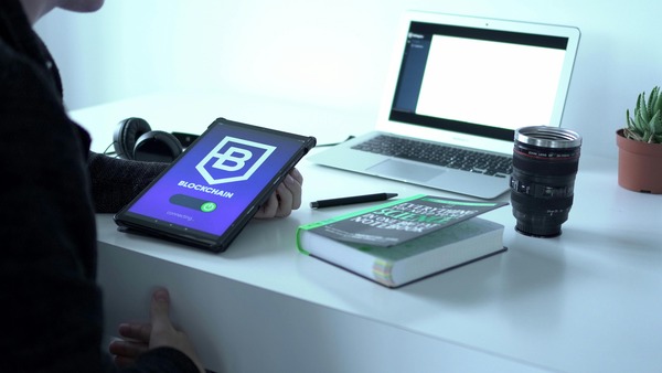 Tablet with a blockchain app on a desk
