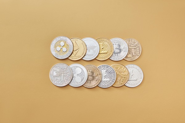 Crypto coins arranged on a beige background