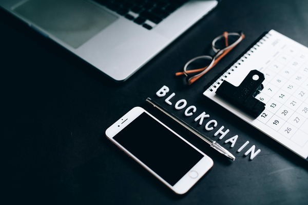 Blockchain letter tiles with a phone and glasses