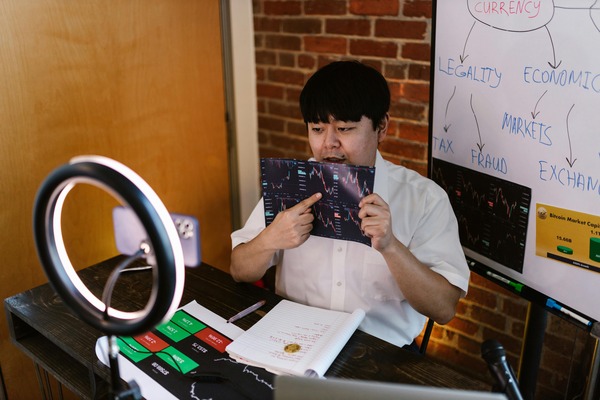 Person reading at a desk with a ring light