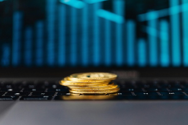 Stack of gold coins on a laptop keyboard