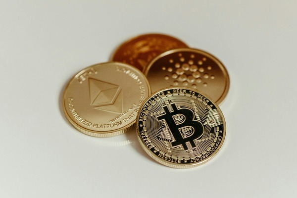 Ethereum, cardano and bitcoin coins on white