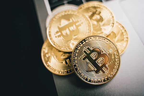 Gold bitcoin coins on a dark table