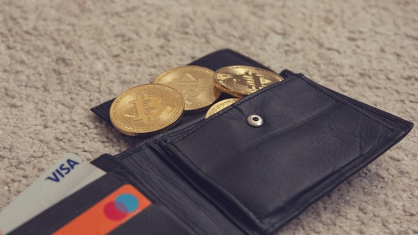 Wallet with gold bitcoin coins and a bank card