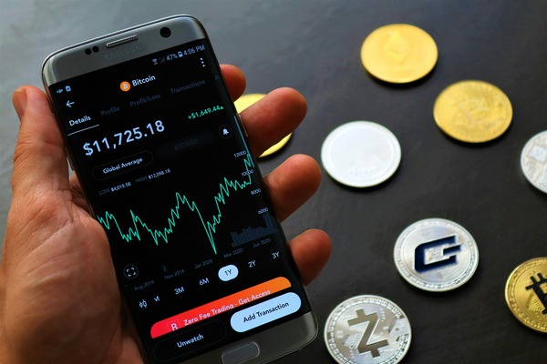 Smartphone with a portfolio chart and coins