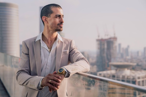 Businessman with a watch on a city balcony