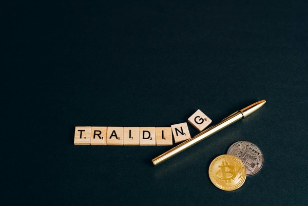 Trading letter tiles with a pen and coins