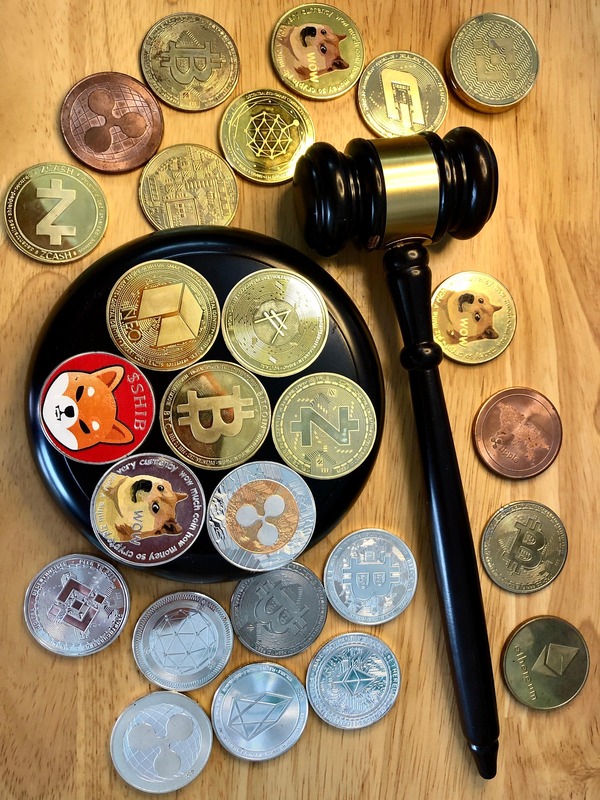Judge gavel on a tray of crypto coins