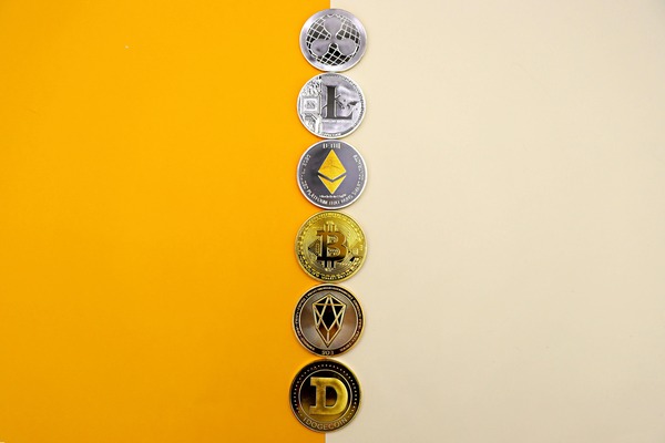 Crypto coins in a vertical row on yellow