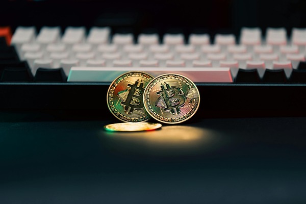 Bitcoin coins on a backlit keyboard