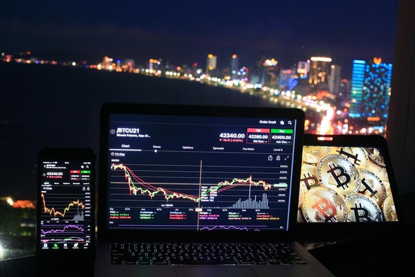 Laptop and phone with charts at night