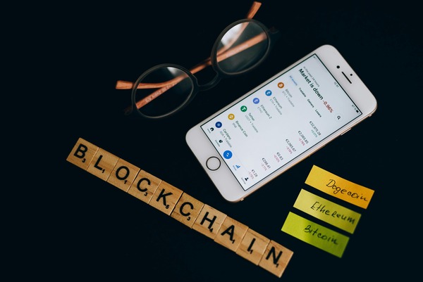 Blockchain letter tiles next to a smartphone