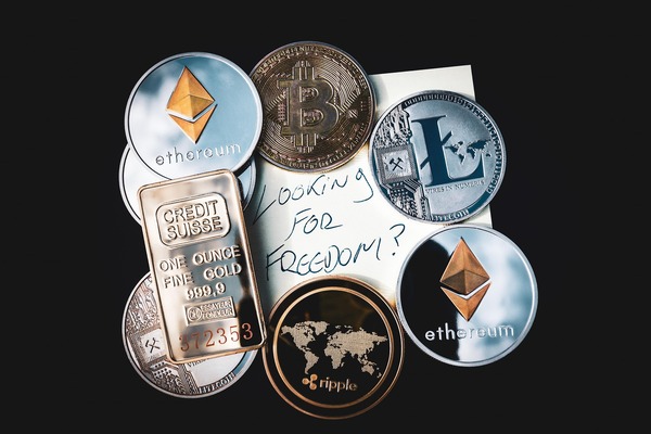 Crypto coins with a gold bar and a note